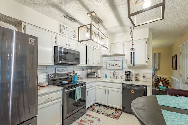 kitchen with pendant lighting, stainless steel appliances, white cabinets, and sink