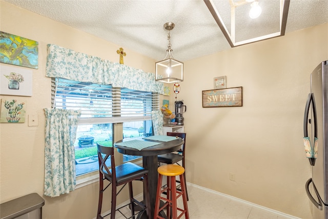 dining room featuring a textured ceiling