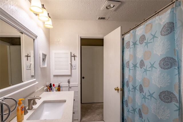 bathroom featuring vanity and a textured ceiling