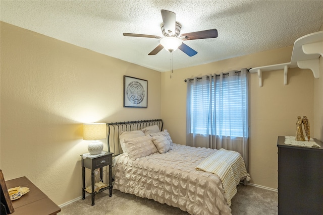 bedroom with ceiling fan, a textured ceiling, and carpet