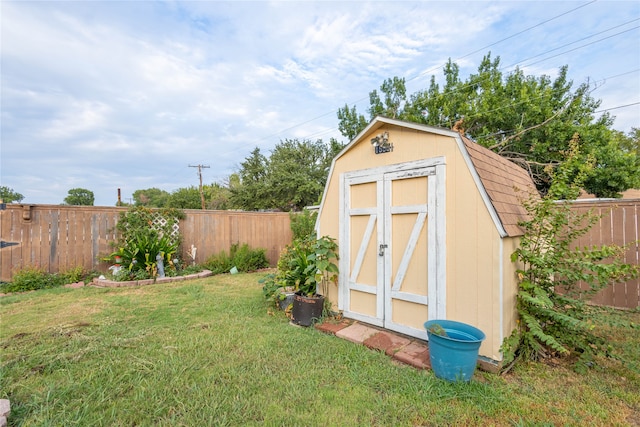 view of outdoor structure featuring a lawn