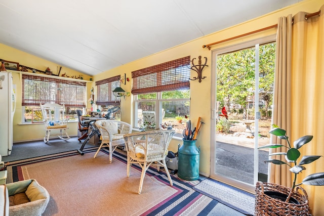 sunroom / solarium with lofted ceiling and a wealth of natural light