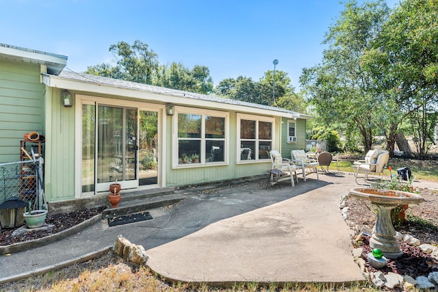 rear view of property featuring a patio area