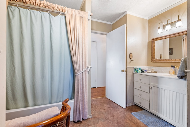 bathroom featuring shower / bath combo with shower curtain, a textured ceiling, vanity, and crown molding