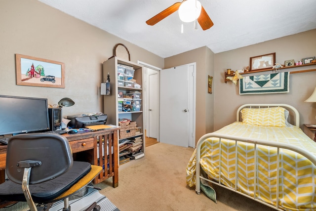 bedroom featuring light carpet and ceiling fan