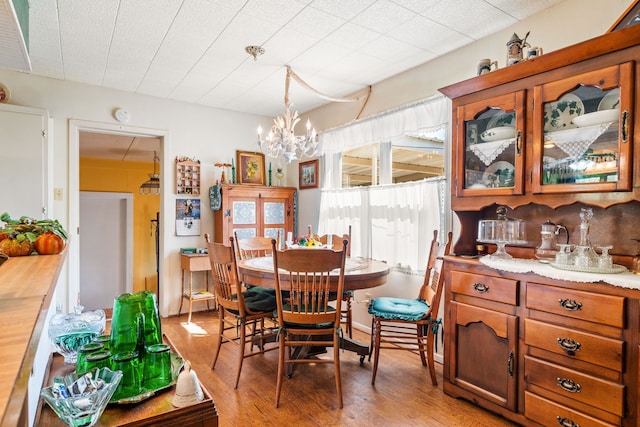 dining area featuring light wood-type flooring and a chandelier