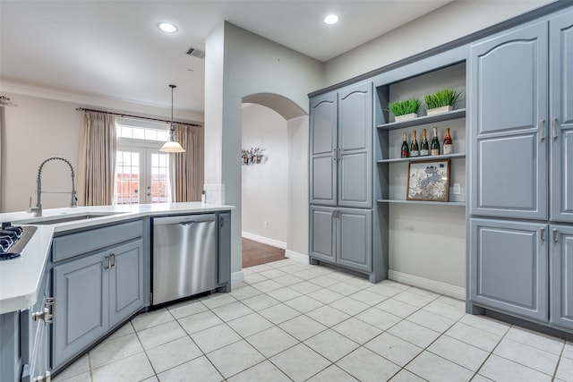 kitchen featuring light tile patterned floors, decorative light fixtures, stainless steel dishwasher, and sink