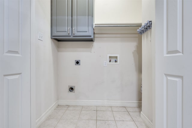 clothes washing area featuring cabinets, washer hookup, light tile patterned floors, and electric dryer hookup