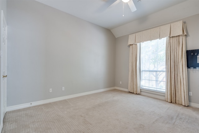 empty room featuring light colored carpet, ceiling fan, and lofted ceiling