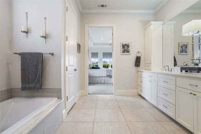 bathroom featuring tile patterned floors, tiled tub, vanity, and crown molding