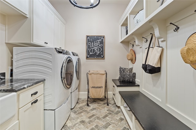 washroom with cabinets and washing machine and clothes dryer