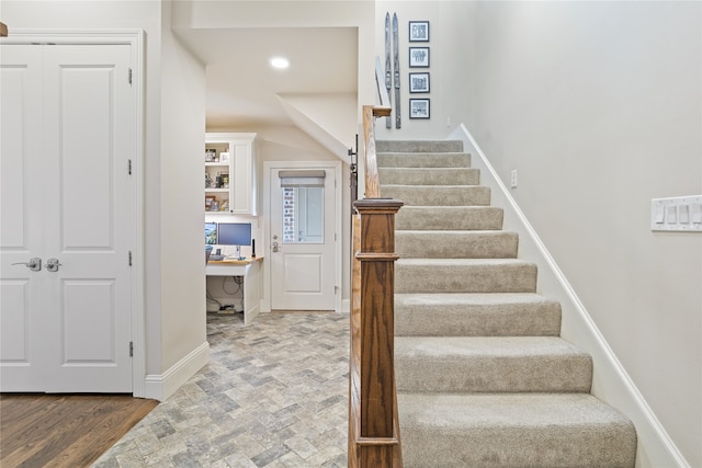 stairway with hardwood / wood-style floors