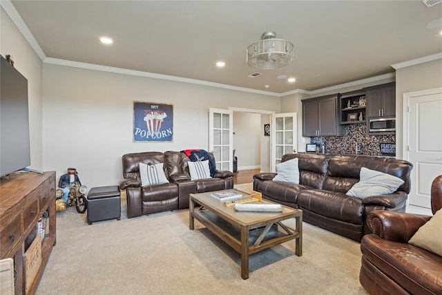 carpeted living room with ornamental molding and french doors