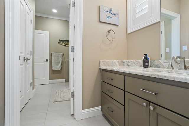 bathroom featuring ornamental molding, tile patterned floors, and vanity