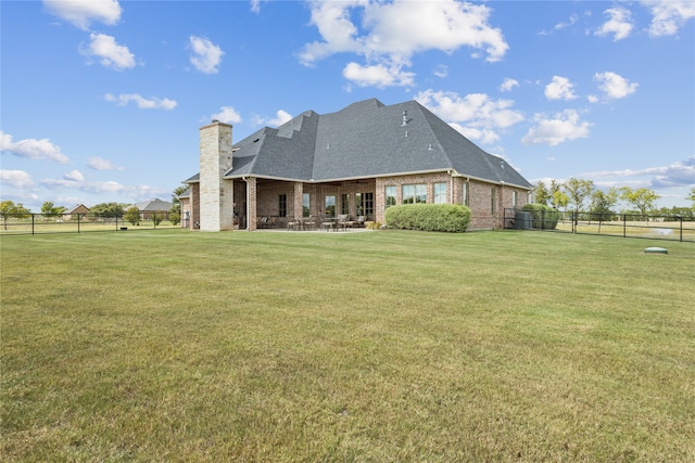 rear view of house with a yard