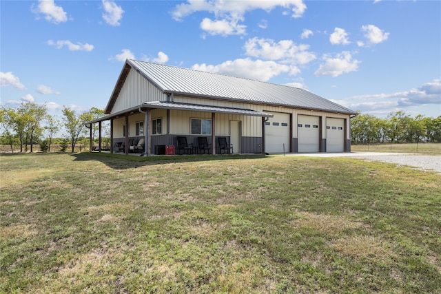 view of front of house with a porch, a garage, and a front lawn