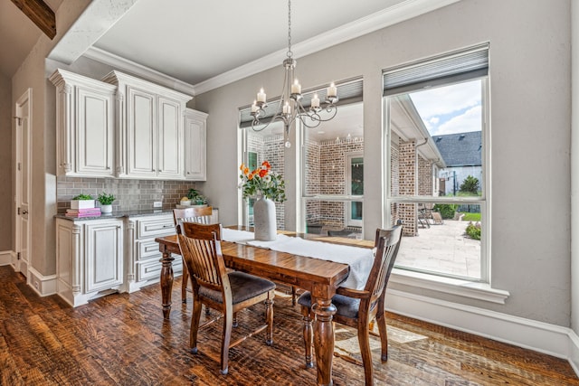 dining room with plenty of natural light, dark hardwood / wood-style floors, and an inviting chandelier