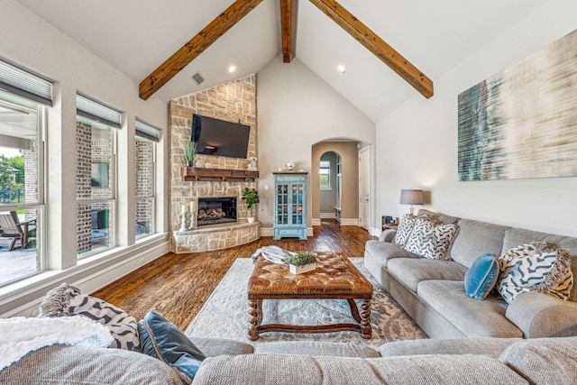 living room featuring beam ceiling, a fireplace, high vaulted ceiling, and hardwood / wood-style flooring