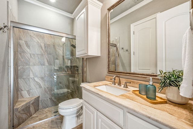 bathroom with vanity, toilet, a shower with shower door, and ornamental molding