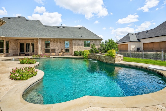 view of pool with pool water feature and a patio