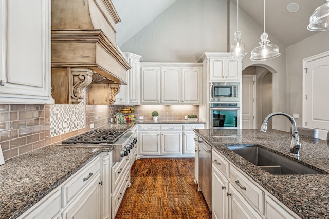 kitchen featuring white cabinetry, sink, hanging light fixtures, and appliances with stainless steel finishes