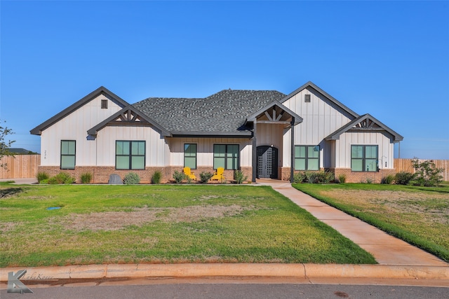 modern farmhouse featuring a front yard