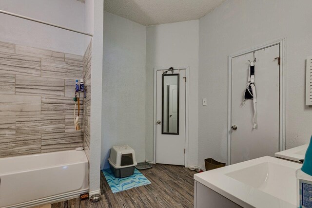 613 Purple Sage Trl, Mesquite, TX 75149 - bathroom with wood finished floors, vanity, a textured ceiling, and shower / tub combination