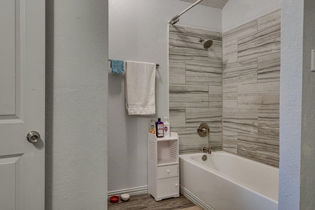 613 Purple Sage Trl, Mesquite, TX 75149 - full bathroom featuring a textured wall, wood finished floors, and washtub / shower combination