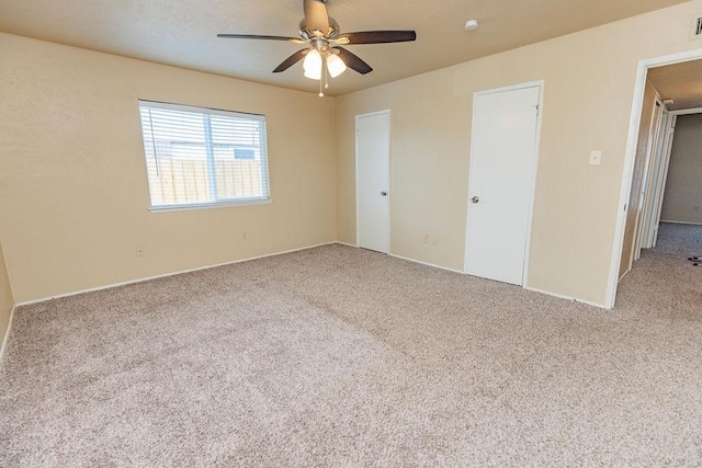 unfurnished bedroom featuring light colored carpet and ceiling fan