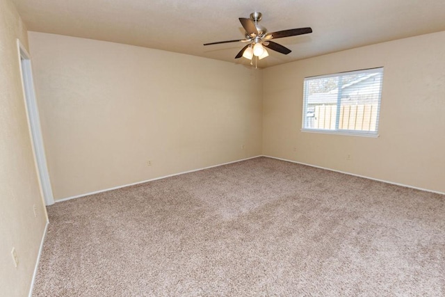 carpeted spare room featuring ceiling fan