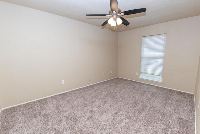 spare room with carpet and ceiling fan