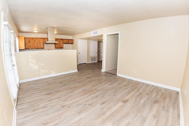 unfurnished living room with light hardwood / wood-style floors