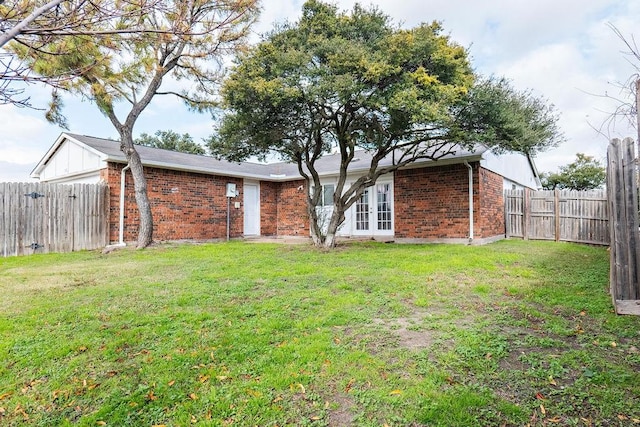 rear view of house with a lawn