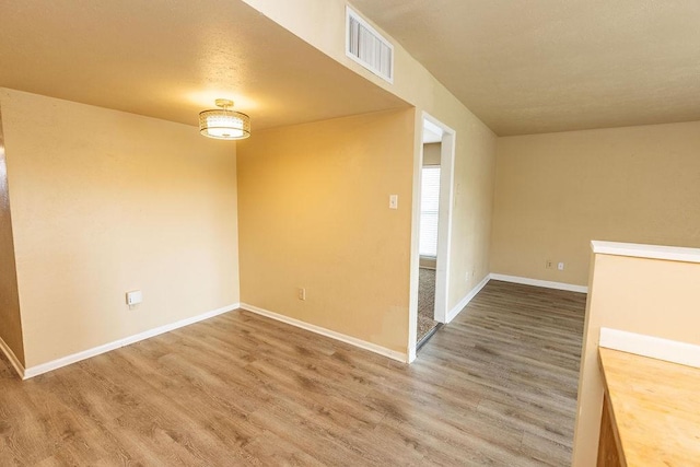 empty room with hardwood / wood-style flooring