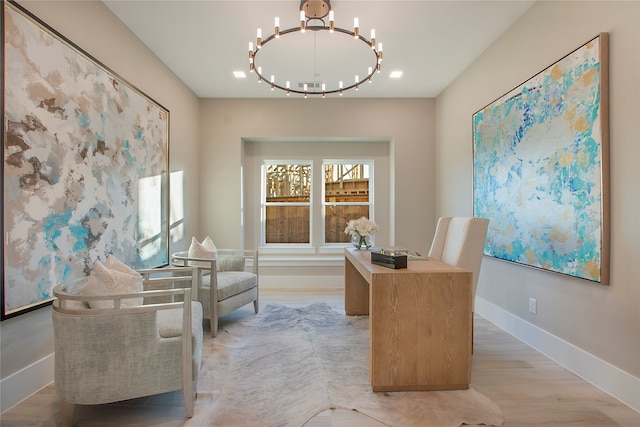 home office featuring a chandelier and light hardwood / wood-style flooring