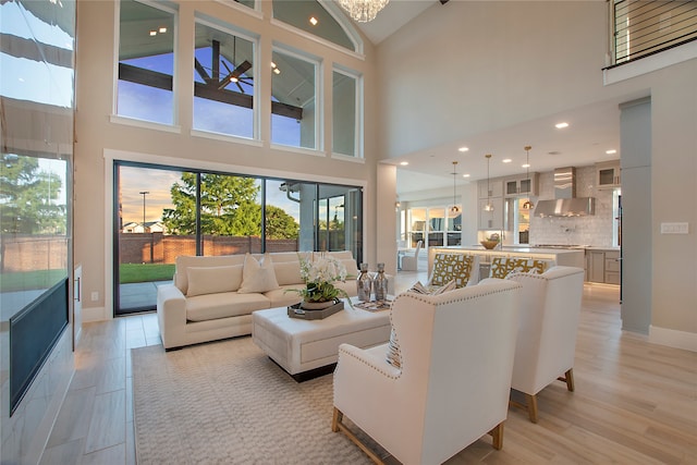 living room with high vaulted ceiling and light hardwood / wood-style floors