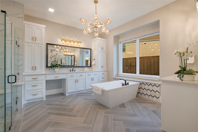 bathroom with vanity, an inviting chandelier, parquet flooring, and plus walk in shower