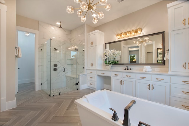 bathroom with a notable chandelier, parquet floors, vanity, and separate shower and tub