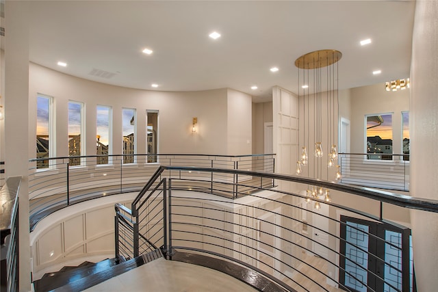 hallway featuring a notable chandelier