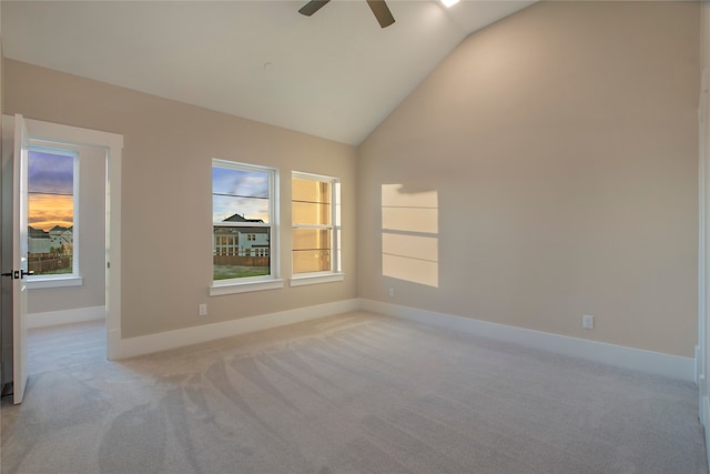 empty room with light carpet, ceiling fan, and high vaulted ceiling