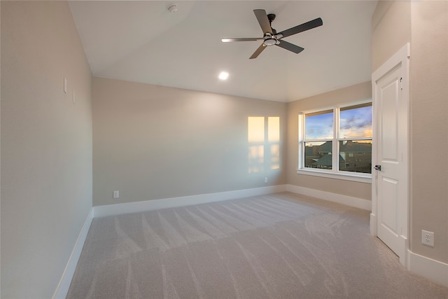 unfurnished room featuring lofted ceiling, light carpet, and ceiling fan