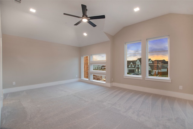 unfurnished living room featuring vaulted ceiling, light carpet, and ceiling fan