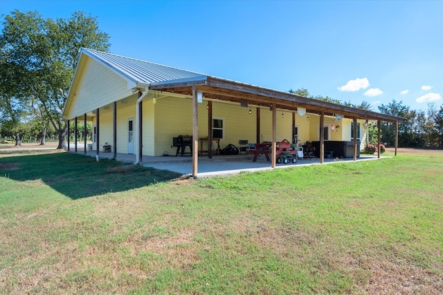 back of house with a patio and a yard