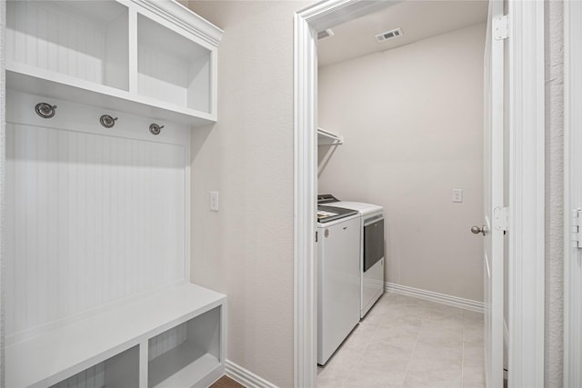 laundry room with light tile patterned flooring and washer and dryer