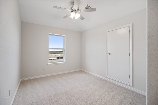 empty room with light carpet and ceiling fan