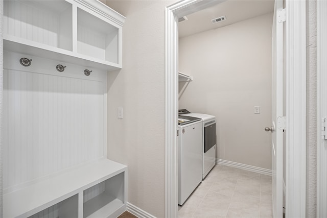 washroom featuring washer and clothes dryer and light tile patterned floors