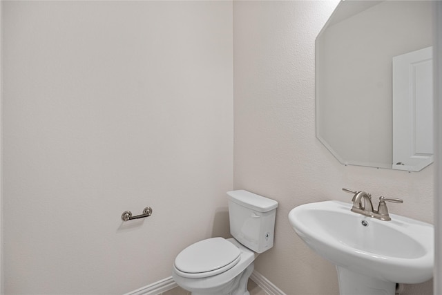 bathroom featuring sink and toilet