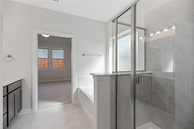 bathroom with plus walk in shower, tile patterned floors, and vanity