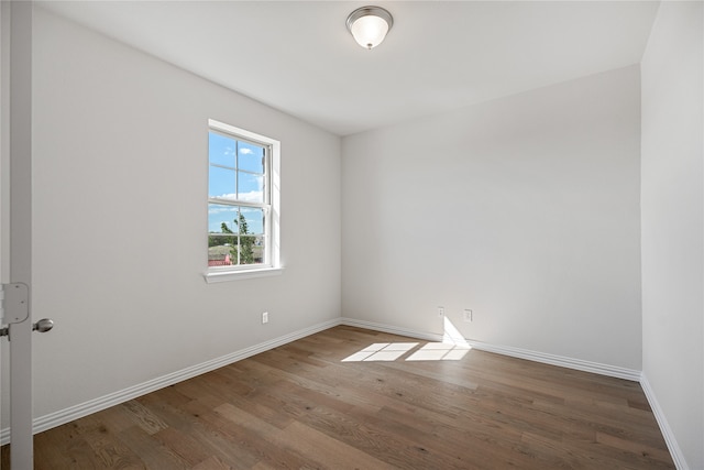 empty room with hardwood / wood-style floors