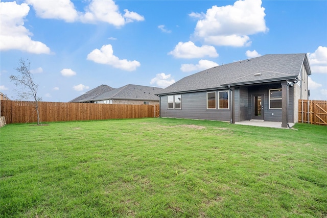 back of property with a patio area and a lawn